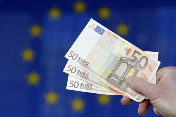 Traders watching European bond yield data on financial monitors.